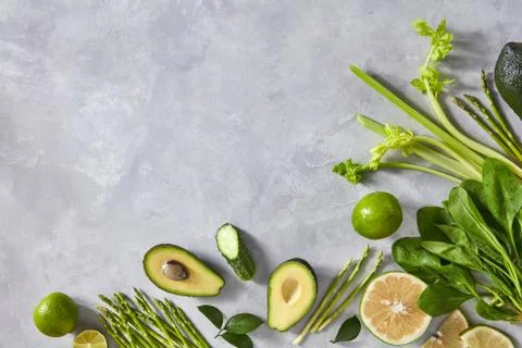 Corner frame of different green vegetables on a gray concrete background with 写真素材