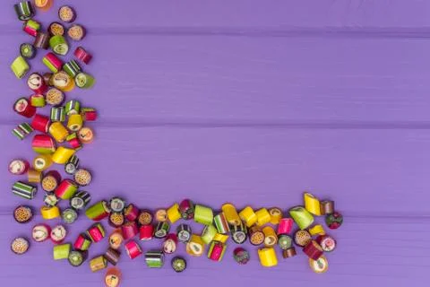 A corner frame made of colored caramel candies Stock Photos