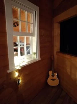 Corner guitar &amp; window Stock Photos