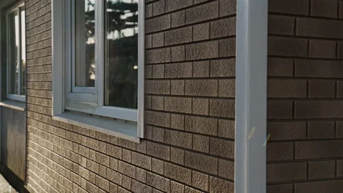 The corner of house is made of flexible facade panels with window and door Stock Footage 166468970