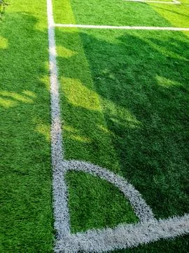 Corner kick mark on green grass field Stock Photos