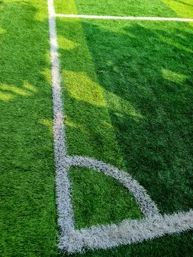 Corner kick mark on green grass field Stock Photos