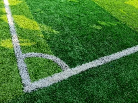 Corner kick mark on green grass field Stock Photos