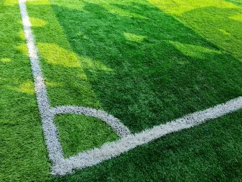 Corner kick mark on green grass field Stock Photos