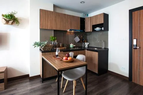 Corner kitchen with dining table in the room condominium. Stock Photos