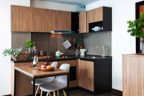 Corner kitchen with dining table in the room condominium. Stock Photos
