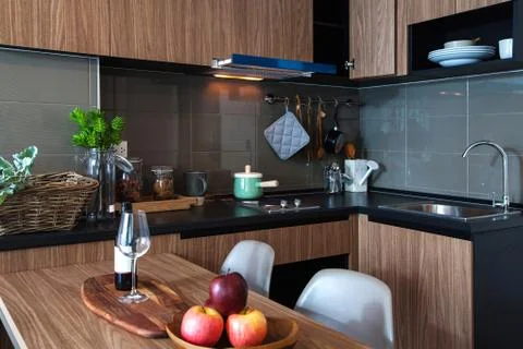 Corner kitchen with dining table in the room condominium. Stock Photos