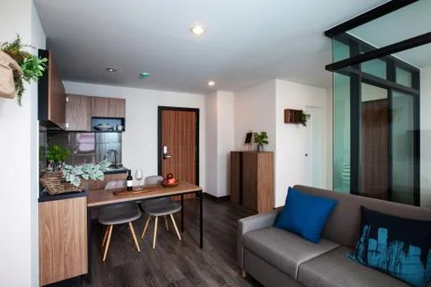 Corner kitchen with dining table in the room condominium. Stock Photos