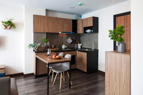 Corner kitchen with dining table in the room condominium. Stock Photos