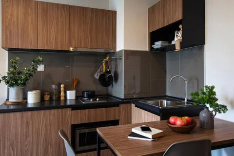 Corner kitchen with dining table in the room condominium. Stock Photos