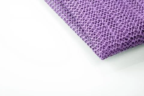 Corner of a lavender colored kitchen napkin on a white background, space for Stock Photos