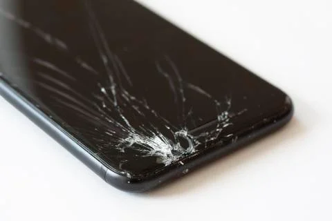 Corner of mobile cell phone with broken display screen after drop. Stock Photos