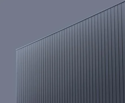Corner of modern building clad in vertical metal panels forms sharp geometric Stock Photos