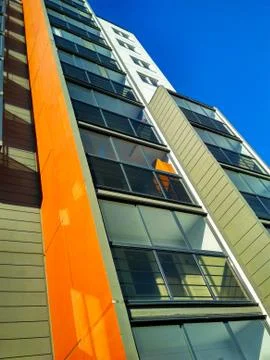 Corner of a multi-storey building against the sky with balconies. Stock Photos