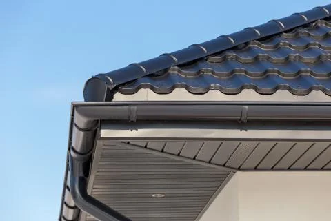 Corner of the new modern house with gutter roof and wall Stock Photos