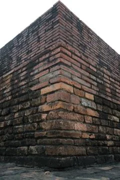 The corner of old brick wall and cloudy sky with selective focus Stock Photos
