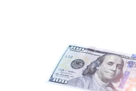 The corner of a one hundred dollar with Benjamin Franklin of the USA close-up Stock Photos