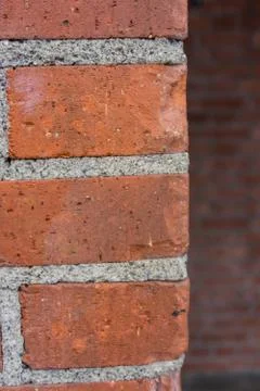 Corner of red brick wall close up Stock Photos