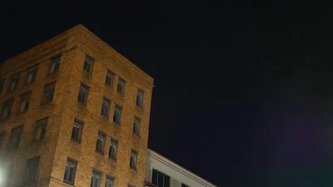 Corner Room Lighting turns on in a old apartment building in the city Stock Footage 85108104