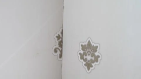 Corner of the room with wallpaper with a pattern. gluing joints Stock Footage 244746217