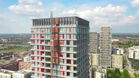 Corner of tall building with construction elevator on side Stock-Footage 156689213