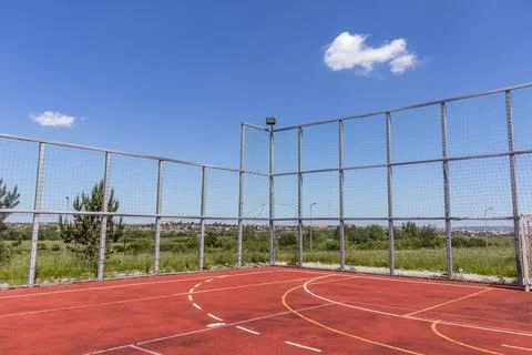 Corner View of Empty Multi Sport Enclosed Court Under Blue Sky Stock Photos