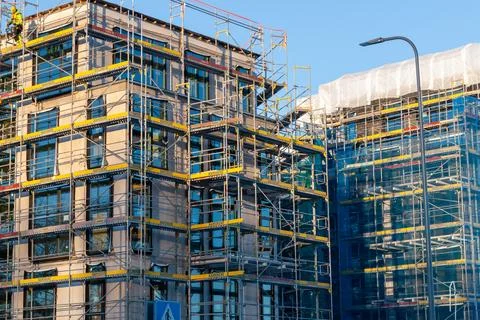 Corner view of multi storey residential construction site with scaffolding Stock Photos