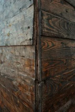 Corner view of a rotten wall made from wood, wooden texture background Stock Photos