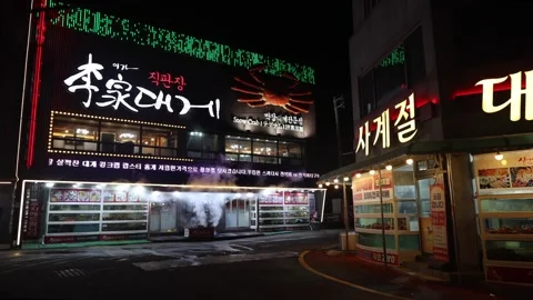 Corner View of Two Steamy Snow Crab Restaurants in Ganggu Port Stock Footage 260207718