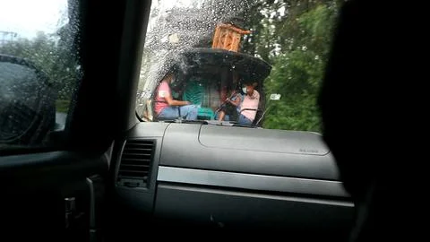 The corner of the wet windshield of the car Stock Photos