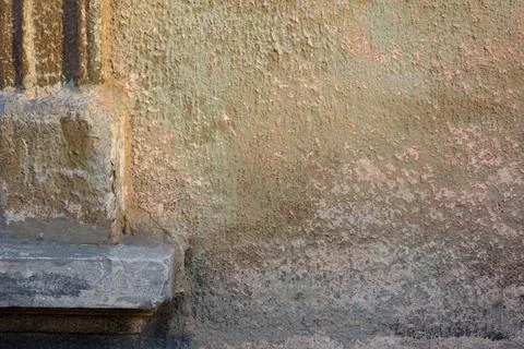 Corner of a window with cement edging and peeling wall with green and carmi.. Stock Photos
