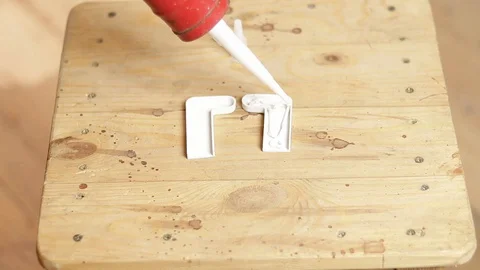 Corner for a window sill. Apply mounting adhesive to the plastic corner Stock Footage 129137858