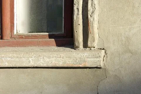 Corner wooden window red frame and glass. Sill and wall texture gray cement.. Stock Photos