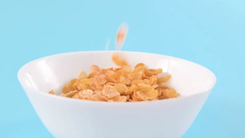 Cornflakes. Dry breakfasts are poured into a bowl. Vitamin food for children and Stock Footage 229866594