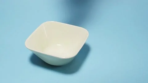 Cornflakes fall into a bowl in slow motion Stock Footage 151794023