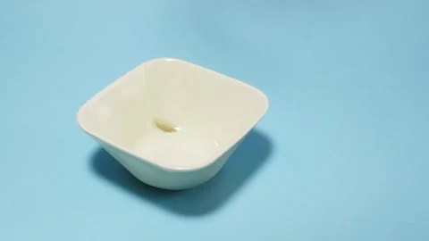 Cornflakes fall into a bowl in slow motion Stock Footage 152167897