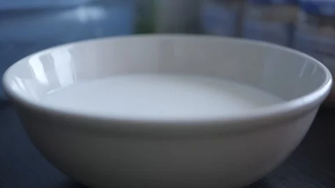 Cornflakes fall into a plate with milk. Slow Motion Video 動画素材 108422454