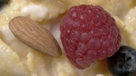 Cornflakes, fresh berries and nuts with yogurt. The dish is close-up. 스톡 동영상 141793082