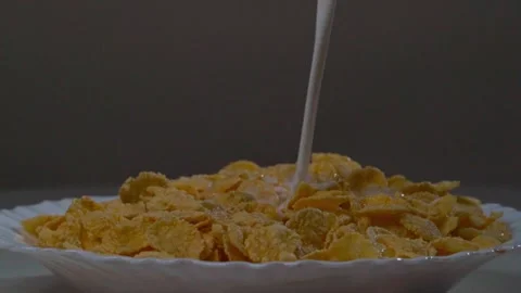 Cornflakes with milk in a plate on the table Stock Footage 140110498
