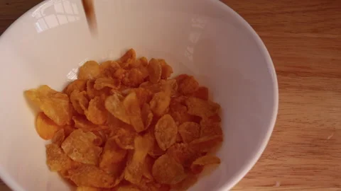Cornflakes poured in bowl Stock Footage