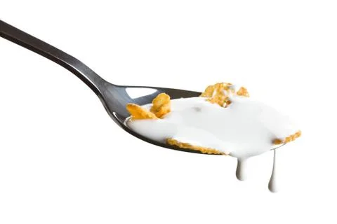 Cornflakes on the spoon with milk Stock Photos