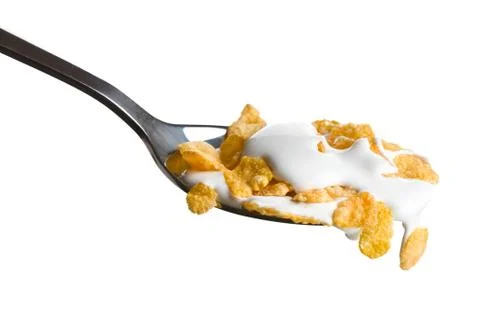 Cornflakes on the spoon with milk Stock Photos