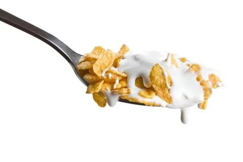 Cornflakes on the spoon with milk Stock Photos