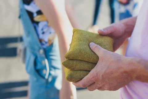 Cornhole game set, process of throwing bean bags, kids children tossing bea.. Stock Photos