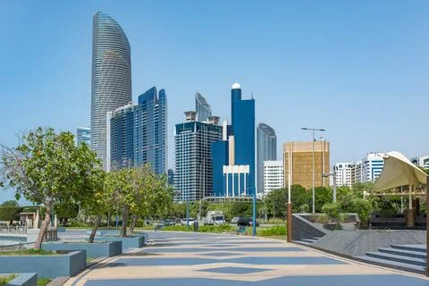Corniche boulevard beach park along the coastline. Modern buildings of down.. Stock Photos