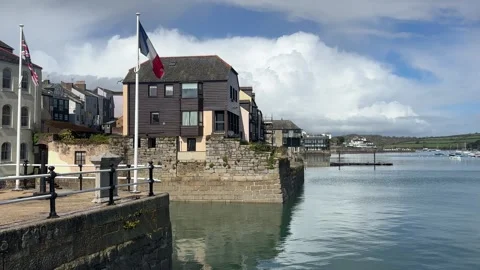 Cornish and French Flags by Tranquil River Fal, Falmouth Waterfront, Cornwall UK Stock Footage 334090305