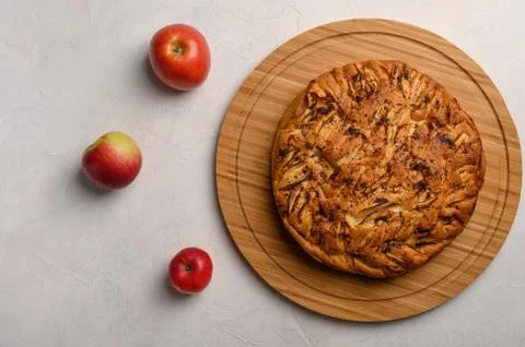 Cornish apple pie top view on rustic style white background. Next to three Stock Photos