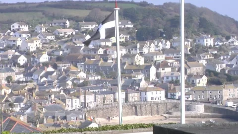 Cornish flag flying in Mousehole Cornwall Stock Footage 277528644