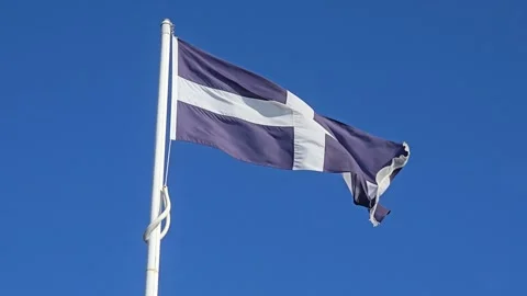 Cornish Flag on Pole Against Blue Sky in Cornwall England Looking Up Stock Footage 332497941