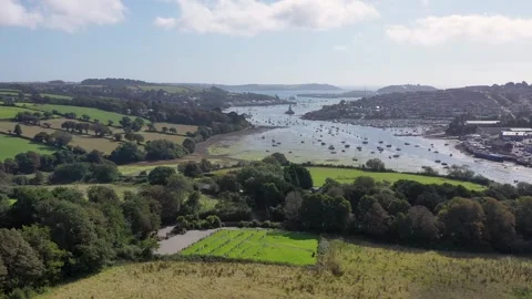 Cornish river estuary, rolling hills and town, boats 4k Stock Footage 320946410